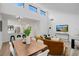 Bright open-concept living area featuring high ceilings, dining area, and a modern kitchen at 2541 Leeward Way, Winter Park, FL 32792
