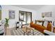 Comfortable living room featuring modern decor, a plush sofa, and sliding glass doors to the outdoors at 2541 Leeward Way, Winter Park, FL 32792