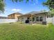 Spacious backyard with a covered patio, grill, and well-maintained lawn at 2604 Bullion Loop, Sanford, FL 32771