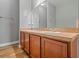Bathroom with a double vanity, wood-look flooring, and a large mirror at 2604 Bullion Loop, Sanford, FL 32771