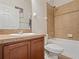 Cozy bathroom featuring a shower-tub combo with tiled surround, vanity, and a toilet at 2604 Bullion Loop, Sanford, FL 32771