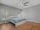 Bedroom with modern wood flooring, a ceiling fan, and natural light from two windows at 2604 Bullion Loop, Sanford, FL 32771