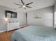 Bedroom featuring wood floors, a ceiling fan, and a white dresser at 2604 Bullion Loop, Sanford, FL 32771