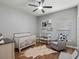 Well-designed Bedroom featuring a crib, changing table, chair, cow print accents, and a ceiling fan at 2604 Bullion Loop, Sanford, FL 32771