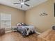 Comfortable bedroom with a bed, side table, and wood-look flooring at 2604 Bullion Loop, Sanford, FL 32771