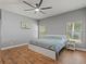 Bedroom with modern wood flooring, a ceiling fan, and natural light from two windows at 2604 Bullion Loop, Sanford, FL 32771