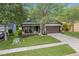 Charming single-story home with a well-manicured front yard, porch, and a two-car garage at 2604 Bullion Loop, Sanford, FL 32771