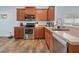 Well-equipped kitchen featuring stainless steel appliances and wood-look flooring at 2604 Bullion Loop, Sanford, FL 32771