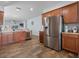 Kitchen with stainless steel refrigerator, open to the dining and living areas at 2604 Bullion Loop, Sanford, FL 32771