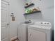 Functional laundry room with a washer, dryer, shelves, and ample storage space at 2604 Bullion Loop, Sanford, FL 32771