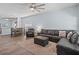 Open-concept living room with a large sectional sofa, dining table, and wood-look floors at 2604 Bullion Loop, Sanford, FL 32771