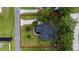 Aerial view of the property and surrounding parcel boundaries, with surrounding lush greenery at 2707 Carmel Ct, Kissimmee, FL 34746
