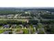 An aerial view of a lovely home in a tranquil neighborhood surrounded by mature trees and lush greenery at 2707 Carmel Ct, Kissimmee, FL 34746