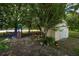 The backyard boasts a playground and a storage shed nestled under mature trees with lush landscaping at 2707 Carmel Ct, Kissimmee, FL 34746