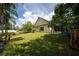 The large yard features a storage shed, mature trees, lush grass, and a wooden fence at 2707 Carmel Ct, Kissimmee, FL 34746