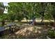 A fully fenced backyard features a playground, and a shady space for outdoor entertaining at 2707 Carmel Ct, Kissimmee, FL 34746