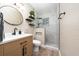 This remodeled bathroom boasts a modern vanity, floating shelves, and a frameless glass shower at 2707 Carmel Ct, Kissimmee, FL 34746