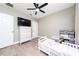 A light-filled bedroom features a dresser with TV, and toy kitchen play area at 2707 Carmel Ct, Kissimmee, FL 34746