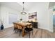 Bright dining room featuring stylish chandelier, wood table, and seating for six at 2707 Carmel Ct, Kissimmee, FL 34746