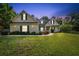 Inviting single Gathering home featuring a well-manicured lawn, tidy landscaping, and welcoming covered porch at 2707 Carmel Ct, Kissimmee, FL 34746