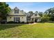 Charming home with a manicured lawn, beautiful landscaping, and welcoming front porch at 2707 Carmel Ct, Kissimmee, FL 34746