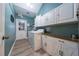 Bright laundry room with built-in storage cabinets and new appliances at 2707 Carmel Ct, Kissimmee, FL 34746