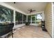 Enjoy the spacious screened porch with views of the backyard, a ceiling fan, and tile flooring at 2707 Carmel Ct, Kissimmee, FL 34746