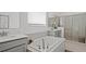 Serene bathroom with a soaking tub, dual vanities, walk-in shower, and plenty of natural light streaming through the window at 2927 Believe In Yourself Ct, Clermont, FL 34714