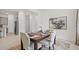 Elegant dining area with dark wood table, four chairs, decorative rug, and a stainless steel fridge in the background at 2927 Believe In Yourself Ct, Clermont, FL 34714