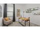 Modern home office with desk, comfortable chair, contemporary artwork, and ample natural light at 2927 Believe In Yourself Ct, Clermont, FL 34714