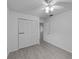 Bright bedroom features a ceiling fan and a large closet with white louvered doors at 309 Kirkcaldy Dr, Winter Springs, FL 32708
