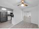 Open-concept kitchen featuring stainless steel appliances, white cabinets and ample counter space at 309 Kirkcaldy Dr, Winter Springs, FL 32708
