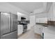 Modern kitchen with white cabinets, stainless steel appliances, and stylish backsplash at 309 Kirkcaldy Dr, Winter Springs, FL 32708