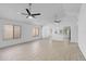 Open living room boasts tile floors, bright windows, and modern ceiling fans at 309 Kirkcaldy Dr, Winter Springs, FL 32708