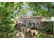Charming backyard features a patio area with seating, grill, and fenced yard at 3121 Natoma Way, Orlando, FL 32825