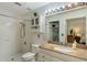Bathroom featuring a sink, toilet, walk-in shower, and storage cabinets at 3121 Natoma Way, Orlando, FL 32825