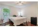 Bedroom featuring wood floors, a ceiling fan, and a large window at 3121 Natoma Way, Orlando, FL 32825