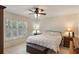 Bright bedroom featuring tile floors, neutral walls, large windows, and a ceiling fan at 3121 Natoma Way, Orlando, FL 32825