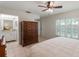 This bedroom features tile floors, a ceiling fan, and an ensuite bathroom with vanity at 3121 Natoma Way, Orlando, FL 32825
