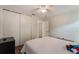 Bedroom with wood floors, a ceiling fan, closet, and access to a bathroom at 3121 Natoma Way, Orlando, FL 32825