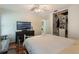 This bedroom features wood floors, a TV, and a closet with shelving at 3121 Natoma Way, Orlando, FL 32825
