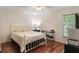 This bedroom features wood floors, a ceiling fan, and a large window at 3121 Natoma Way, Orlando, FL 32825