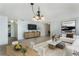 Bright living room featuring neutral tile floors, modern decor, and a stylish chandelier at 3121 Natoma Way, Orlando, FL 32825