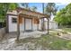 View of backyard shed with covered porch and tropical landscaping at 330 N Stone St, Deland, FL 32720