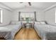 Inviting bedroom with hardwood floors, two twin beds, and a serene ambiance, perfect for restful nights at 330 N Stone St, Deland, FL 32720
