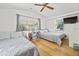 Bright bedroom featuring two beds, a ceiling fan, and natural light from two windows at 330 N Stone St, Deland, FL 32720