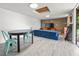 Spacious bonus room with modern lighting, table, and a large blue foldable sofa at 330 N Stone St, Deland, FL 32720