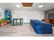 Spacious bonus room with modern lighting, table, and a large blue foldable sofa at 330 N Stone St, Deland, FL 32720