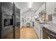 Efficient kitchen featuring black appliances, white cabinets, and plenty of natural light at 330 N Stone St, Deland, FL 32720