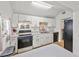 Functional kitchen featuring black appliances, white cabinets, and an open layout at 330 N Stone St, Deland, FL 32720